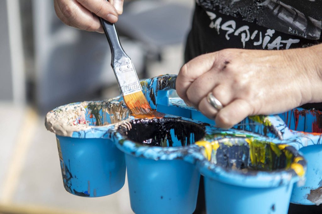 Gina Ribaudo works on a mural at the intersection of Colby and Pacific for the Imagine Childrens Museum in Everett, Washington on Thursday, May 9, 2024. (Annie Barker / The Herald)