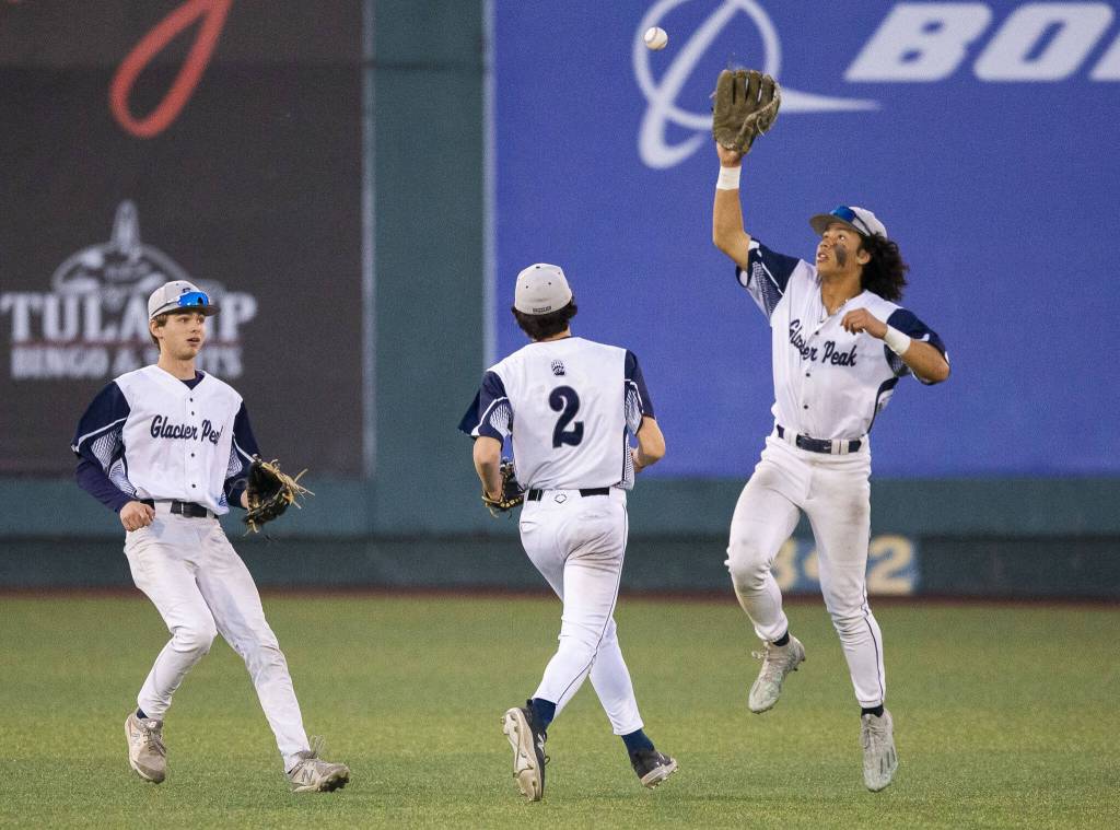 Glacier Peaks Atticus Quist leaps in the air to catch a bouncing baseball after a missed catch in the outfield during the 4A district game against Bothell at Funko Field on Thursday, May 9, 2024 in Everett, Washington. (Olivia Vanni / The Herald)