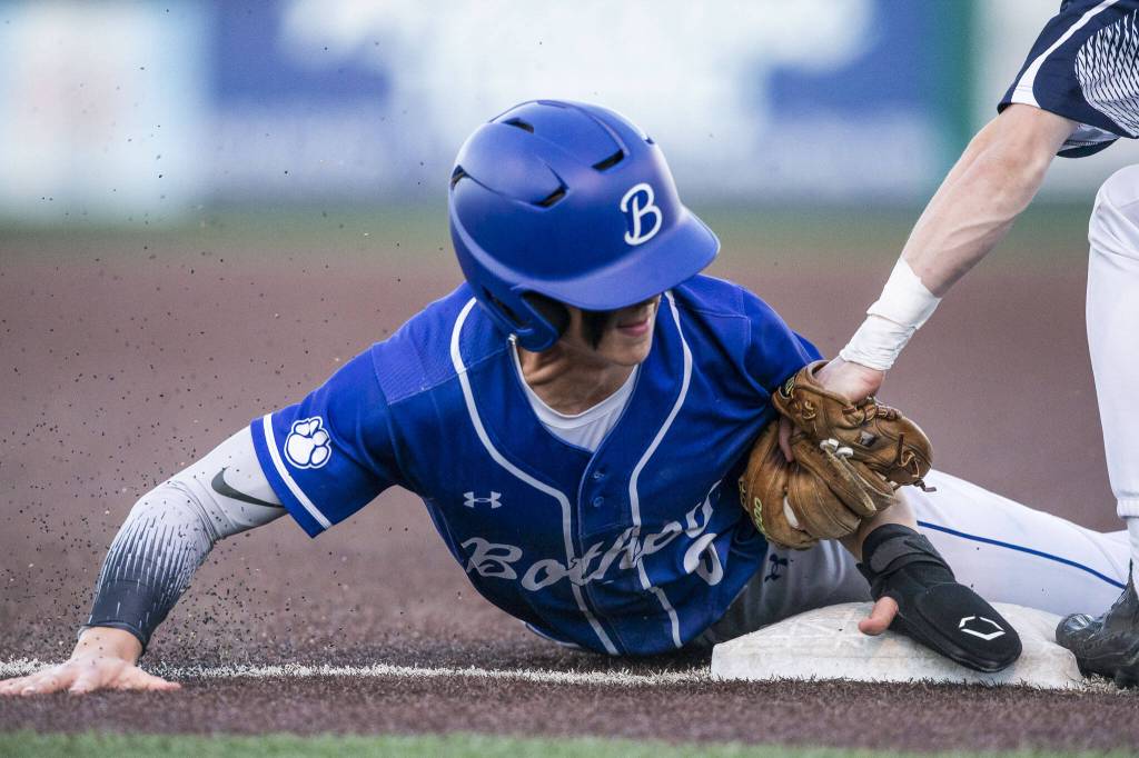 A Bothell player is tagged out at third base by Glacier Peaks Matthew Marquardt during the 4A district game against Bothell at Funko Field on Thursday, May 9, 2024 in Everett, Washington. (Olivia Vanni / The Herald)