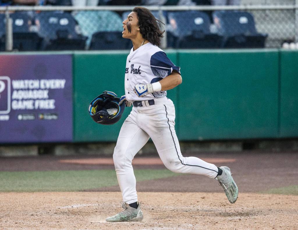 Glacier Peaks Atticus Quist yells and stomps on home plater after scoring during the 4A district game against Bothell at Funko Field on Thursday, May 9, 2024 in Everett, Washington. (Olivia Vanni / The Herald)