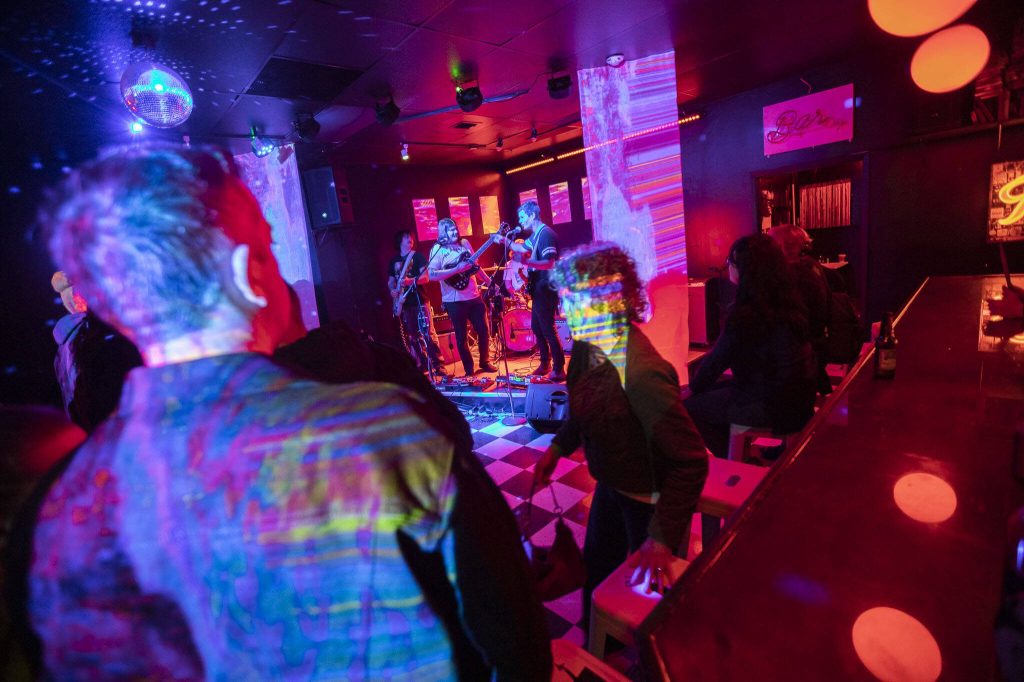 People watch as Dead Energy performs at Lucky Dime during the first day of the Fishermans Village Music Fest on Thursday, May 16, 2024 in Everett, Washington. (Olivia Vanni / The Herald)