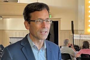 Attorney General Bob Ferguson speaks to a reporter as his 2024 gubernatorial campaign launch event gets underway in Seattle, on Saturday, Sept. 9, 2023. ( Jerry Cornfield/Washington State Standard)