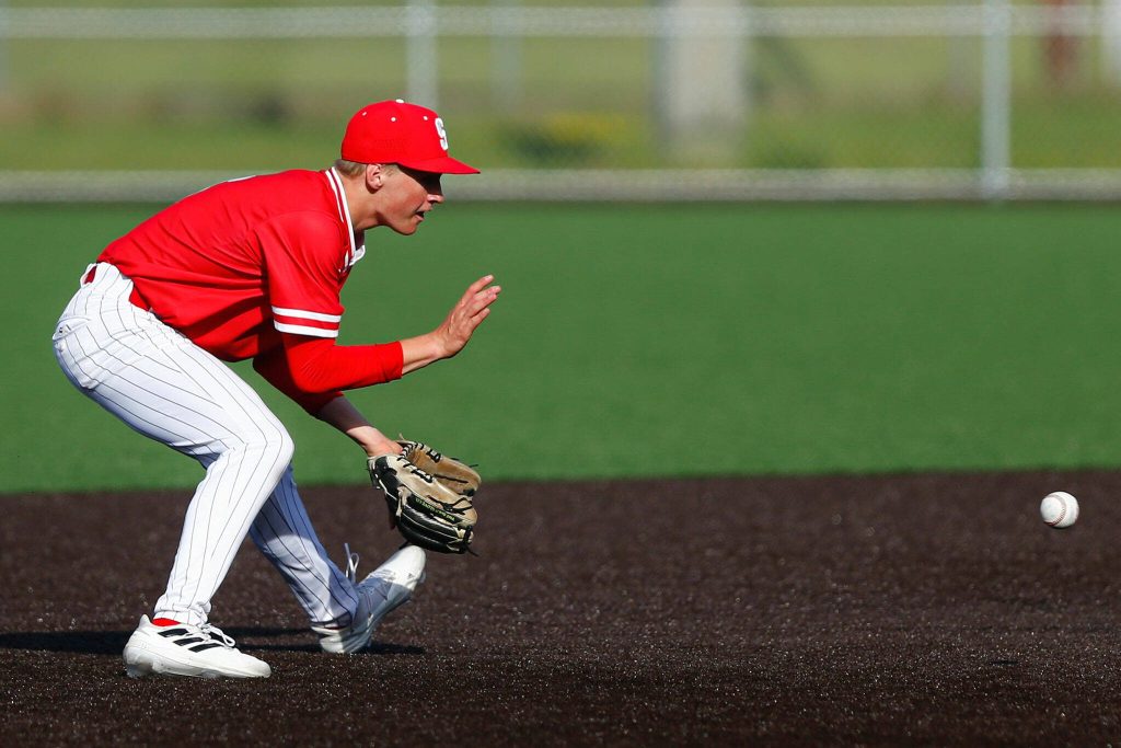 Stanwoods Gavin Gehrman collects a grounder to short and throws out a runner during a playoff loss to Kentlake on Tuesday, May 14, 2024, at Kent Meridian High School in Kent, Washington. (Ryan Berry / The Herald)