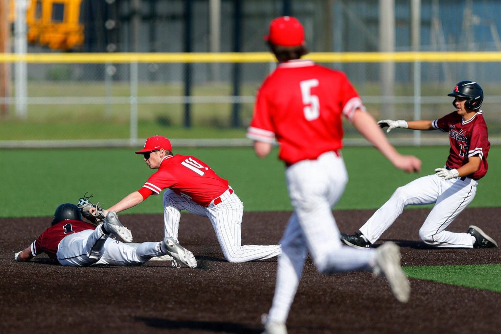 Stanwood sophomore Tanner Requa tags out the lead runner after getting him in a pickle during a playoff loss to Kentlake on Tuesday, May 14, 2024, at Kent Meridian High School in Kent, Washington. (Ryan Berry / The Herald)