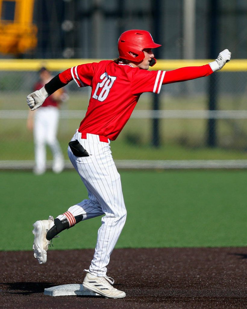 Stanwoods Braedon Requa turns to his dugout and pulls a dance move after reaching second base during a playoff loss to Kentlake on Tuesday, May 14, 2024, at Kent Meridian High School in Kent, Washington. (Ryan Berry / The Herald)