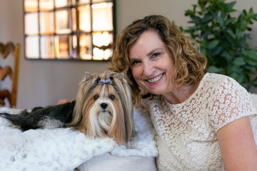 Pippin the Biewer Terrier and her owner Kathy West take a photo together at the West household on Monday, May 20, 2024, in Marysville, Washington. (Ryan Berry / The Herald)