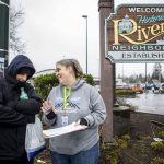 Catholic Community Services NW Director of Housing Services and Everett Family Center Director Rita Jo Case, right, speaks to Jason Browning, left, during a point-in-time count of people facing homelessness in Everett, Washington on Tuesday, Jan. 24, 2023. Browning sometimes stays along Casino Road and tries to help clean up after others in the area. (Annie Barker / The Herald)