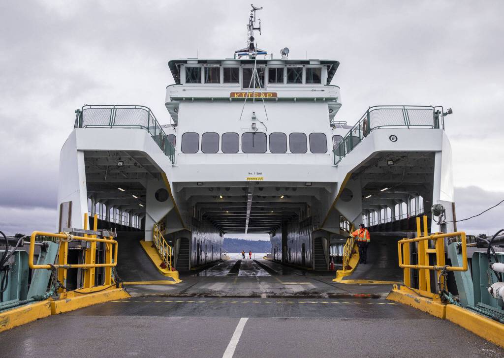 Ferry workers wait for cars to start loading onto the M/V Kitsap on Friday, Dec. 1, 2023 in  Mukilteo, Washington. (Olivia Vanni / The Herald)
