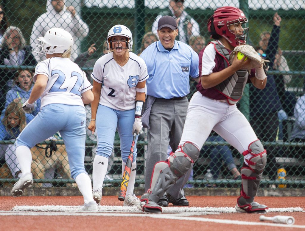Gig Harbor players celebrate scoring during the 3A state softball tournament game against Cascade on Thursday, May 23, 2024 in Lacey, Washington. (Olivia Vanni / The Herald)