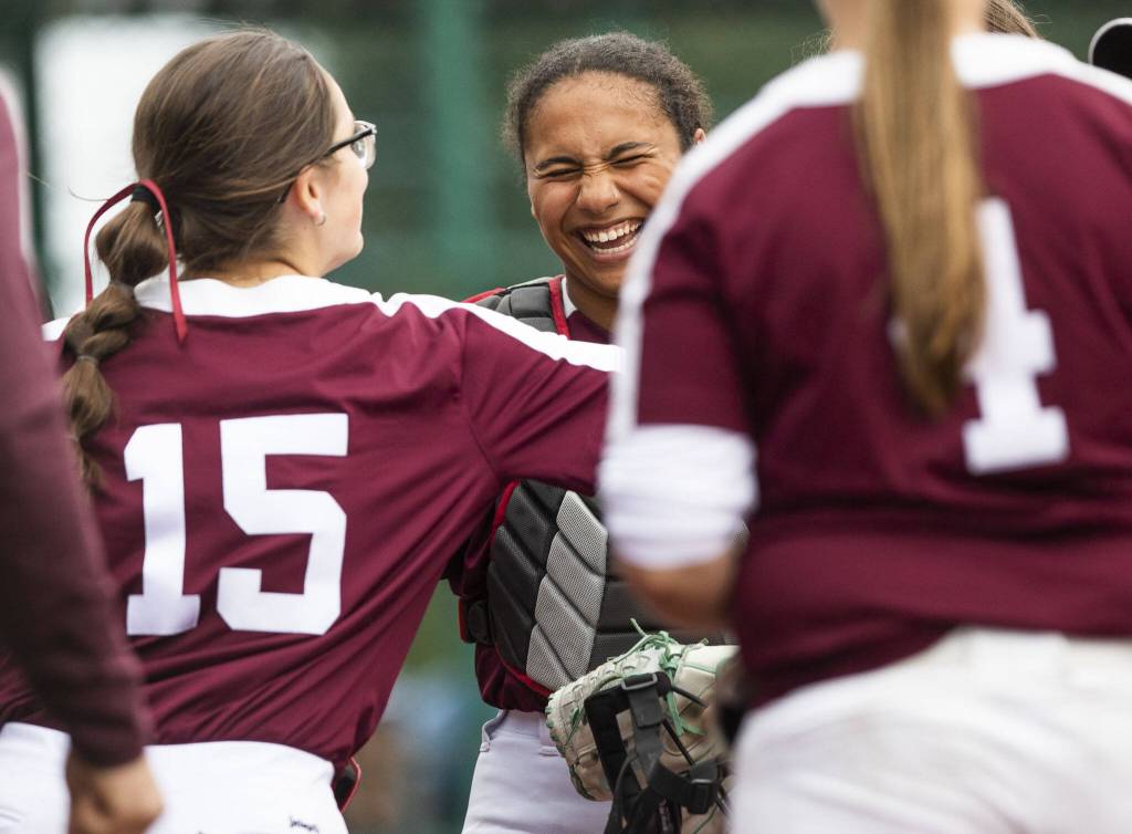 Cascades Jaidyn Wilson laughs with teammates during the 3A state softball tournament game against Gig Harbor on Thursday, May 23, 2024 in Lacey, Washington. (Olivia Vanni / The Herald)