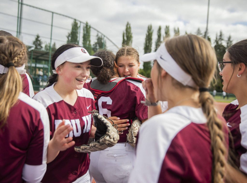 Cascade players celebrate beating Gig Harbor to advance in the 3A state softball tournament on Thursday, May 23, 2024 in Lacey, Washington. (Olivia Vanni / The Herald)