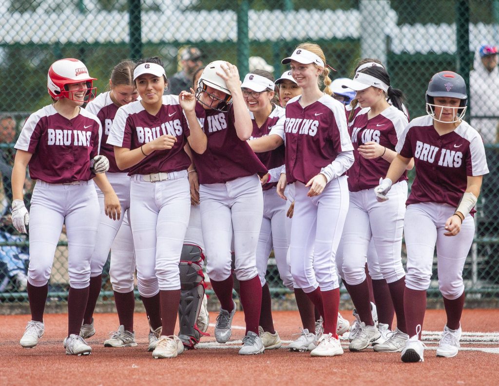 Cascade players congratulate teammate Sophia Tripp on her home run during the 3A state softball tournament game against Gig Harbor on Thursday, May 23, 2024 in Lacey, Washington. (Olivia Vanni / The Herald)