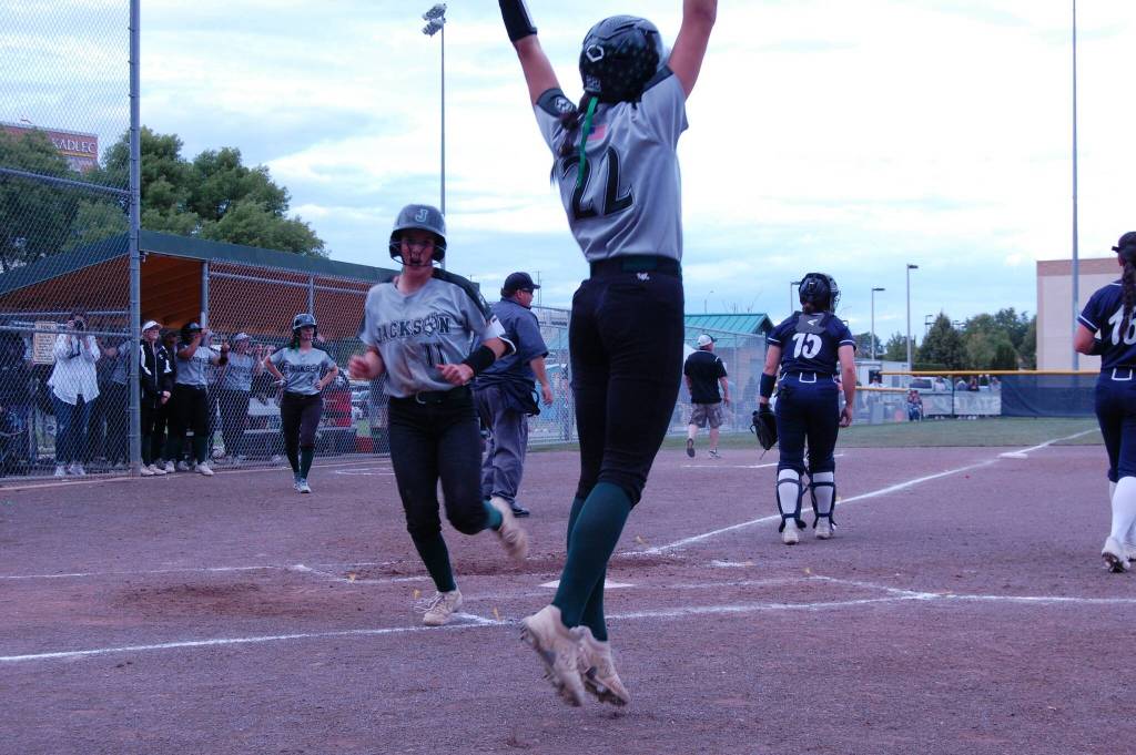 Allie Thomsen jumps for joy as Rachel Sysum scores Jacksons 11th run in a shutout of Olympia in a Class 4A state playoff second-round game May 24 at Columbia Playfields in Richland, WA (Aaron Coe / The Herald).