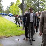 Council member Steve Woodard stops to point out a trail during a tour and discussion with community leaders regarding the Mountlake Terrace Main Street Revitalization project on Tuesday, May 28, 2024, in Mountlake Terrace, Washington. (Ryan Berry / The Herald)