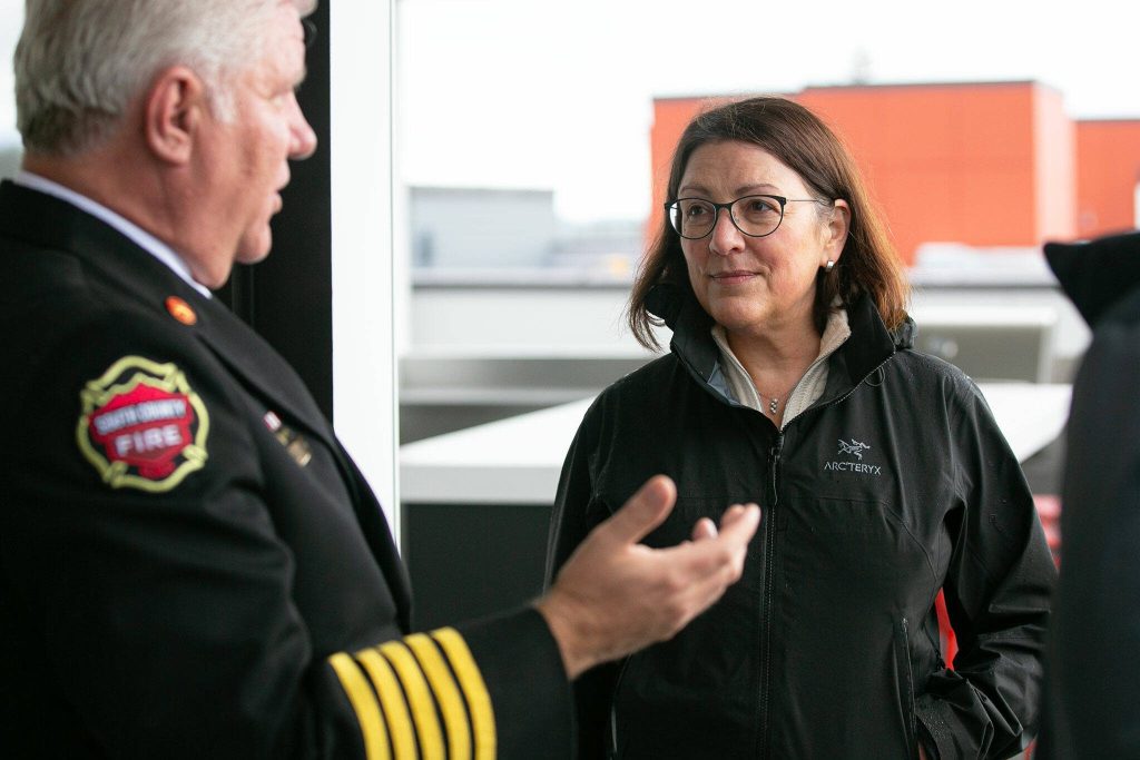 Rep. Suzan DelBene and South County Fire Chief Bob Eastman chat during a tour and discussion with community leaders regarding the Mountlake Terrace Main Street Revitalization project on Tuesday, May 28, 2024, at the Traxx Apartments in Mountlake Terrace, Washington. (Ryan Berry / The Herald)
