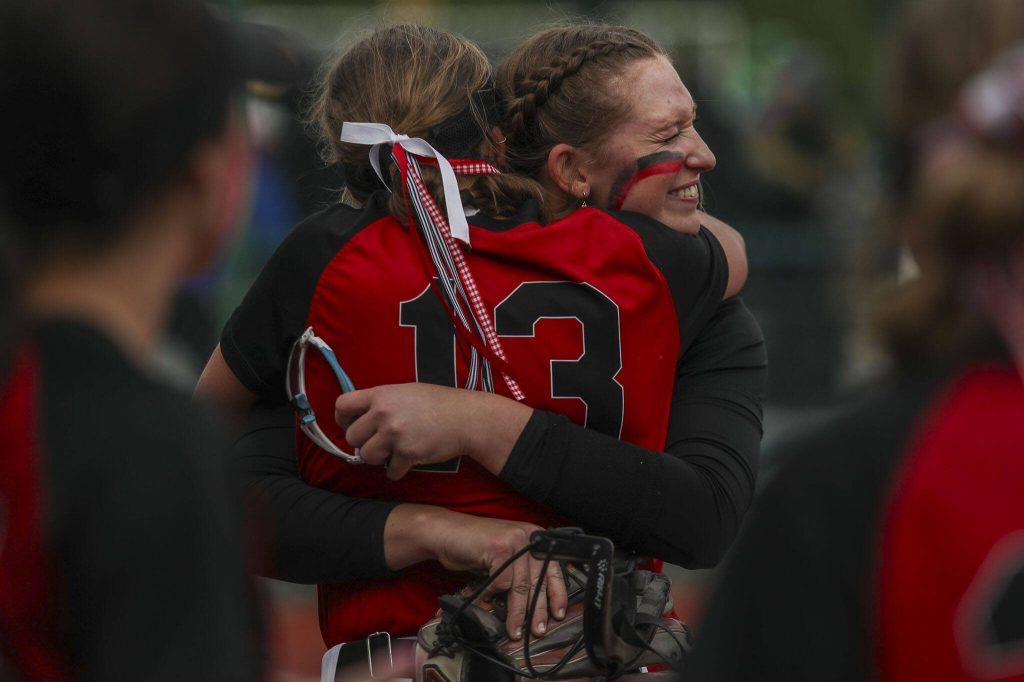 Snohomish players hug during a 3A softball game between Snohomish and Seattle Prep at the regional athletic complex in Lacey, Washington on Friday, May 24, 2024. Snohomish won, 8-0. (Annie Barker / The Herald)
