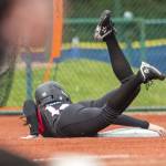Snohomishs Madalynn Larsen grabs onto third base to avoid sliding past it during the 3A state softball semifinal game against Garfield on Saturday, May 25, 2024 in Lacey, Washington. (Olivia Vanni / The Herald)