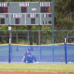 Snohomishs Avery Clark begins to stand up after chasing a ball over the back net during the 3A state softball semifinal game against Garfield on Saturday, May 25, 2024 in Lacey, Washington. (Olivia Vanni / The Herald)