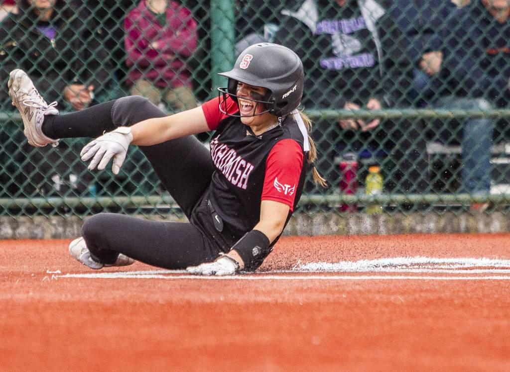 Snohomishs Alexandra Flohr slides into home to score during the 3A state softball semifinal game against Garfield on Saturday, May 25, 2024 in Lacey, Washington. (Olivia Vanni / The Herald)