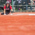 Snohomishs Alexandra Flohr yells as she slides across home plate to score during the 3A state softball semifinal game against Garfield on Saturday, May 25, 2024 in Lacey, Washington. (Olivia Vanni / The Herald)
