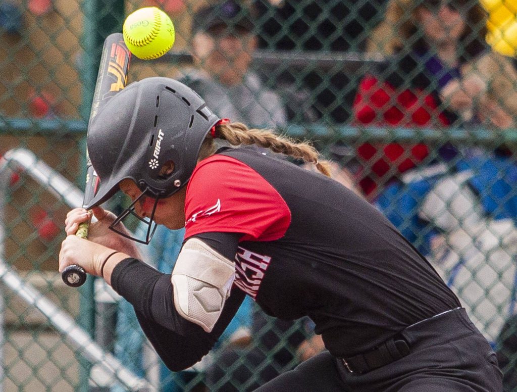 Snohomishs Abby Edwards gets hit in the head with a pitch during the 3A state softball semifinal game against Garfield on Saturday, May 25, 2024 in Lacey, Washington. (Olivia Vanni / The Herald)