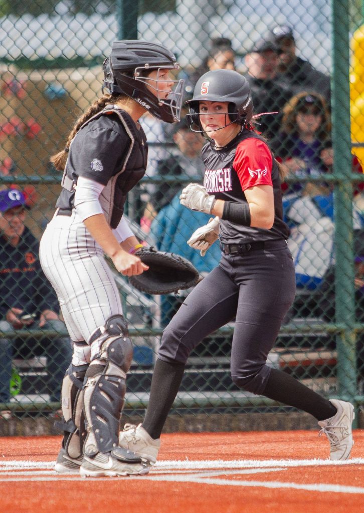 A Snohomish player scores a run during the 3A state softball semifinal game against Garfield on Saturday, May 25, 2024 in Lacey, Washington. (Olivia Vanni / The Herald)