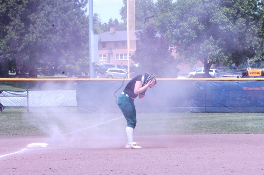 A dust devil surrounds Jackson softball player Hailey Pelletier in a Class 4A state semifinal game May 25 at Columbia Playfield in Richland, WA. (Aaron Coe / The Herald).