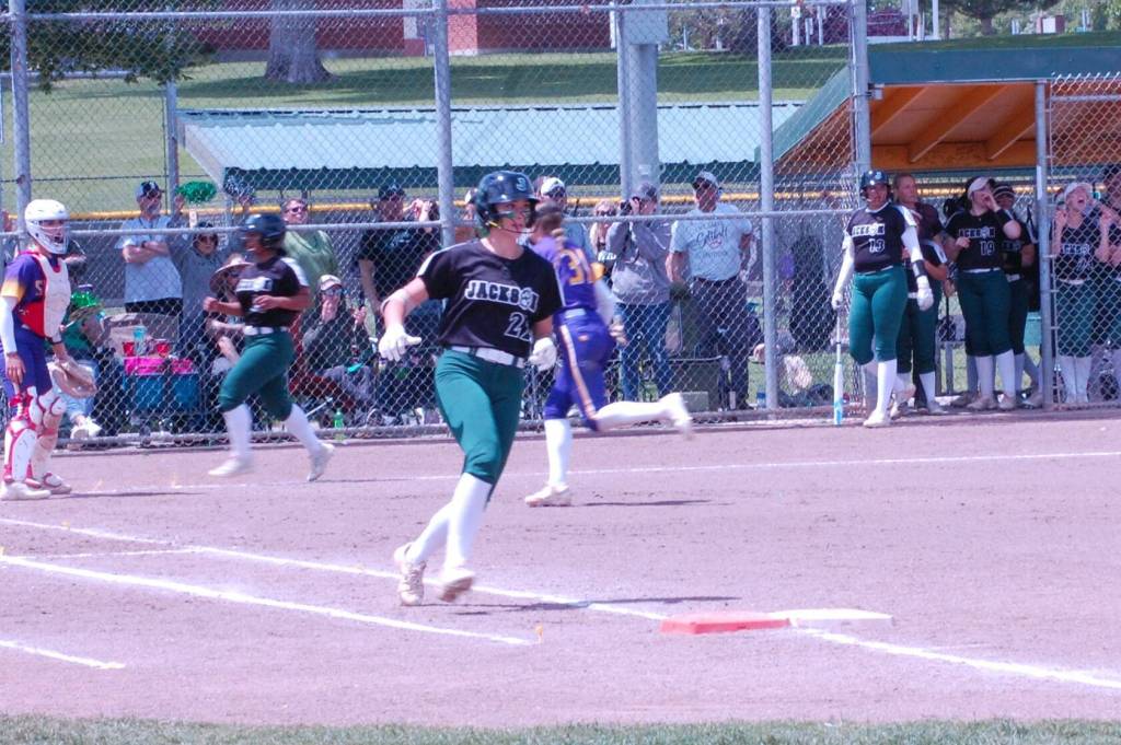Allie Thomsen prepare to round first base as Elena Eigner scores in Jacksons Class 4A softball tournament semifinal victory May 25 at Columbia Playfield in Richland, WA. (Aaron Coe / The Herald).