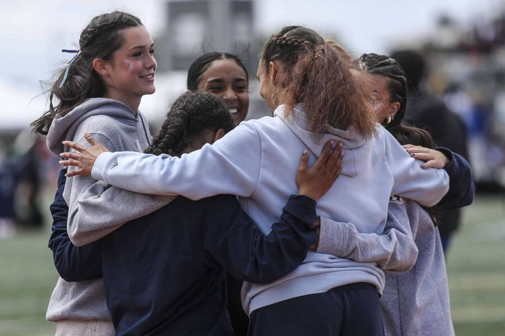 Girls huddle during the Class 4A, 3A, 2A track and field state championships at Mount Tahoma High School in Tacoma, Washington on Saturday, May 25, 2024. (Annie Barker / The Herald)