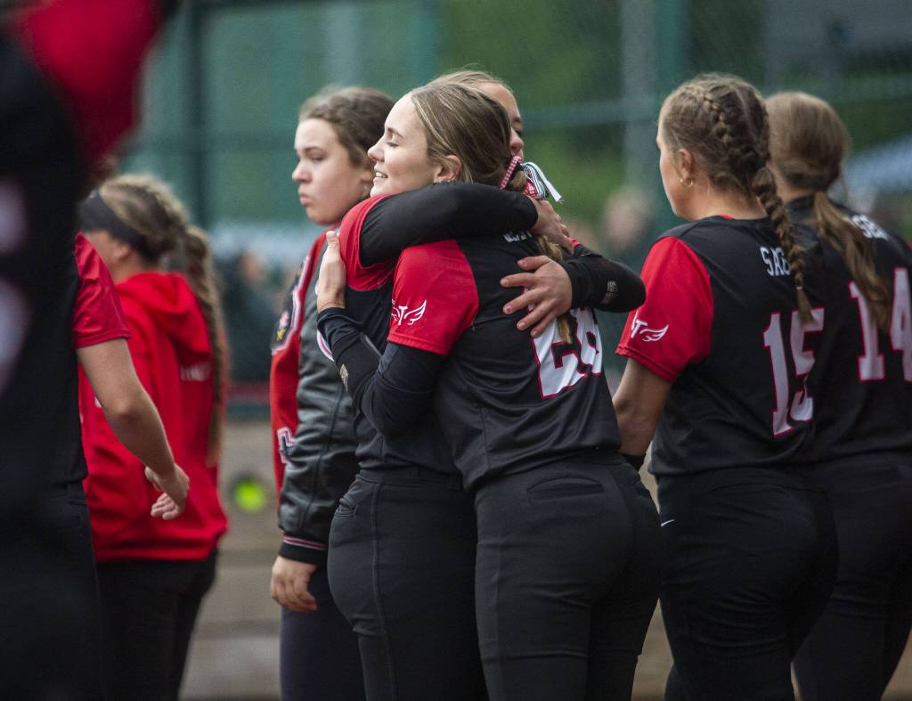 Snohomish players hug after losing to Auburn Riverside in the 3A state softball championship game on Saturday, May 25, 2024 in Lacey, Washington. (Olivia Vanni / The Herald)