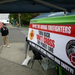 Firefighter Kyle Liston pickets outside of Boeing on Airport Road as the lockout of IAFF Local I-66 Boeing Firefighters approaches two weeks on Thursday, May 16, 2024, in Everett, Washington. The firefighters and other local unions are picketing 24/7 outside an entrance to Boeing’s facility. (Ryan Berry / The Herald)