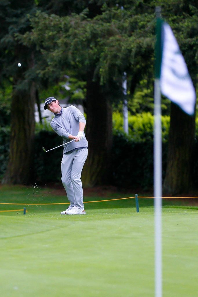 Conrad Chisman chips from the edge of the green towards the hole during the 93rd Annual Snohomish County Amateur Championship on Monday, May 27, 2024, at the Everett Golf and Country Club in Everett, Washington. (Ryan Berry / The Herald)