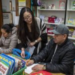 Maricel Samaniego, center, teaches English to Liedith Espana, left, and Nemecio Rios, right, at Liberty Elementary School in Marysville, Washington, on Monday, Jan. 30, 2023. Marysville schools partner with Everett Community College to offer free English classes to parents of multilingual students. (Annie Barker / The Herald)