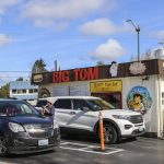 Cars pull up to the Eastside Big Tom drive-thru on March 13 in Olympia, Washington. Big Tom also serves walk-up customers in an outdoor area filled with giant plastic dinosaurs. (Brenda Mann Harrison / Special to The Herald)