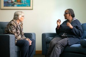 Sixty-one-year-old Jackie McCoy, right, speaks with Nancy Brosemer, mental health programs manager with Homage, on Thursday, May 30, 2024, at the Carl Gipson Center in Everett, Washington. (Ryan Berry / The Herald)