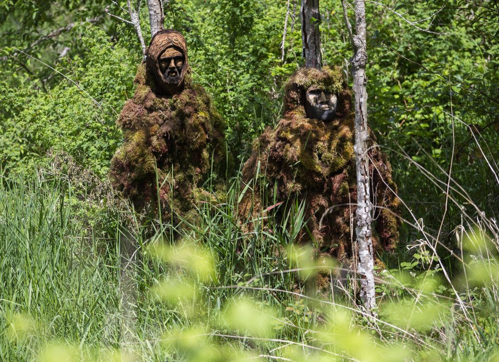 Two new Lake Stevens Bigfoot-Moss Man-Sasquatch along the Stevens Creek stream on Lundeen Parkway in Lake Stevens. (Olivia Vanni / The Herald)
