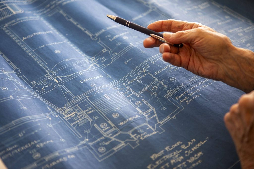 Lawrence E. ODonnell looks at blueprints of Everett High School at his brother Jacks home in Everett, Washington on Wednesday, May 29, 2024. (Annie Barker / The Herald)