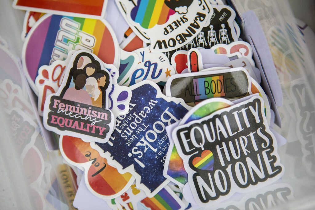 Free stickers are given out during the Stanwood-Camano Pride event at Freedom Park in Camano, Washington on Saturday, June 1, 2024. (Annie Barker / The Herald)