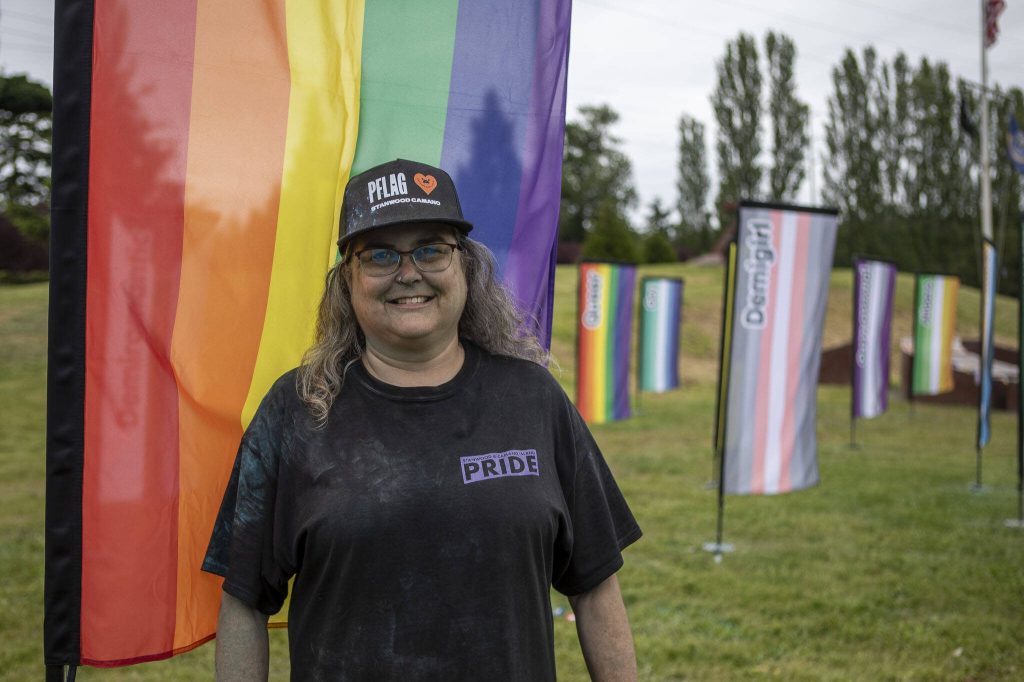 PFLAG president Michelle Huntley poses for a photo post color throw during the Stanwood-Camano Pride event at Freedom Park in Camano, Washington on Saturday, June 1, 2024. (Annie Barker / The Herald)