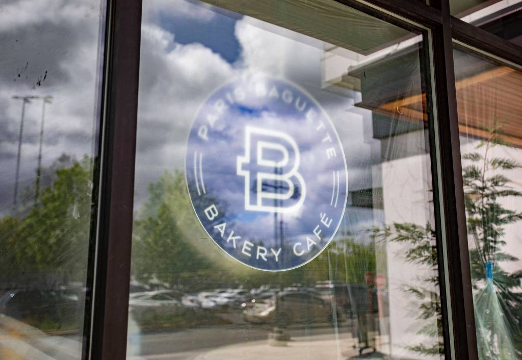 A Paris Baguette sign is visible through a window at the new store next to Alderwood Mall on Thursday, May 30, 2024 in Lynnwood, Washington. (Olivia Vanni / The Herald)
