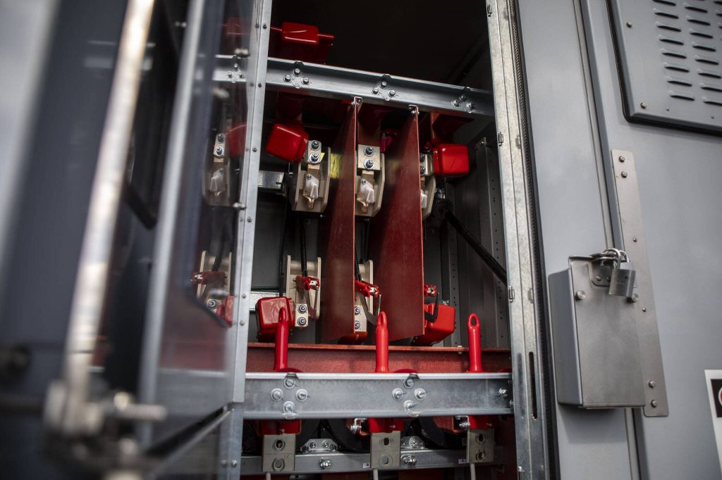 PUD employee Kyle Tucker opens part of the breaker system at the Jennings Park Substation in Marysville, Washington on Wednesday, June 5, 2024. (Annie Barker / The Herald)