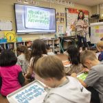 Kimberly Hildenbrand runs through a spelling exercise with her first-grade class on the classrooms Boxlight interactive display board funded by a previous tech levy on March 19, in Lakewood. (Olivia Vanni / The Herald file photo)