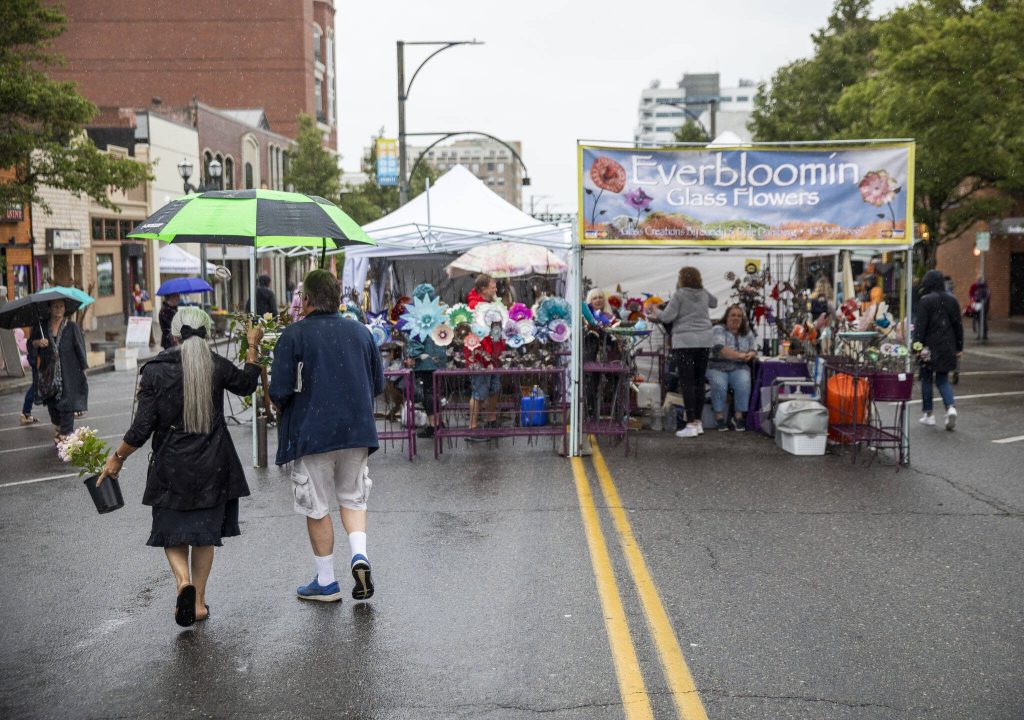 Rain begins to fall during the first day of Sorticulture on Friday, June 9, 2023 in Everett, Washington. (Olivia Vanni / The Herald)