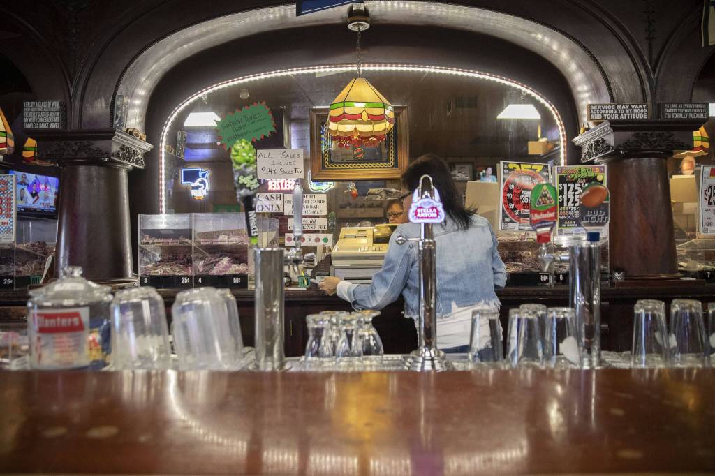 Denise McKenzie, a bartender at Kuhnles Tavern for many years, works behind the bar on June 17, 2024 in Marysville. (Olivia Vanni / The Herald)