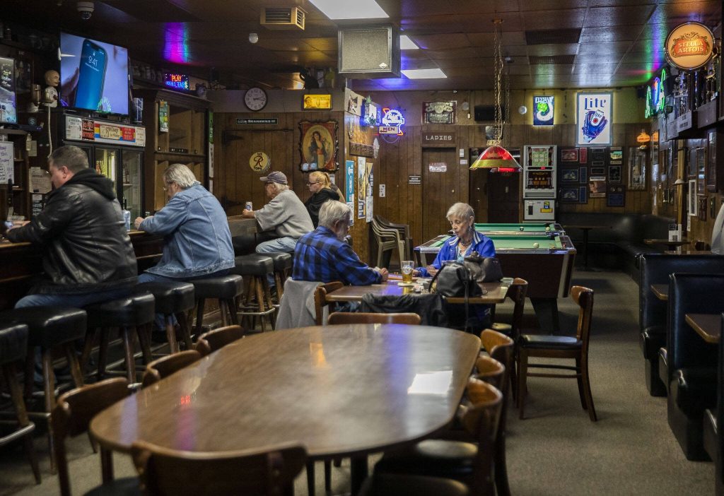People sit at the bar and play table games at Kuhnles Tavern on June 17, 2024 in Marysville. (Olivia Vanni / The Herald)