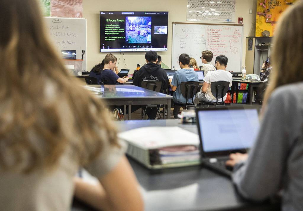 Maplewood Parent Cooperative School seventh and eighth grade students listen to Climate Solutions(?) speak about sustainable construction practices during a science class for the students Sustainable Schools engineering units on Friday, June 7, 2024 in Edmonds, Washington. (Olivia Vanni / The Herald)
