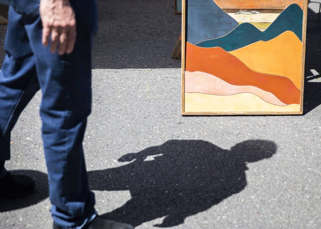A person pauses to look at an art piece during Sorticulture on Friday, June 7, 2024, in Everett, Washington. (Olivia Vanni / The Herald)