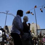 People pause to look at a salmon metal work during Sorticulture on Friday, June 7, 2024, in Everett, Washington. (Olivia Vanni / The Herald)