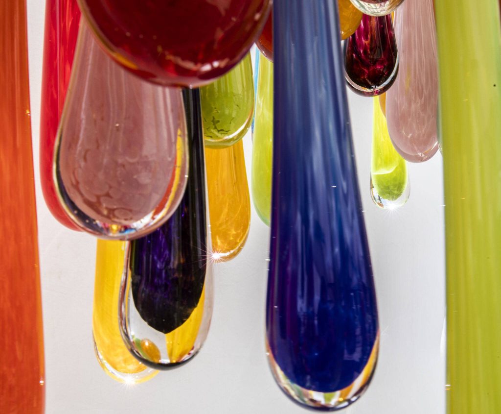 Sunlight reflects through glass art at Merrilee Moore Glass during Sorticulture on Friday, June 7, 2024, in Everett, Washington. (Olivia Vanni / The Herald)