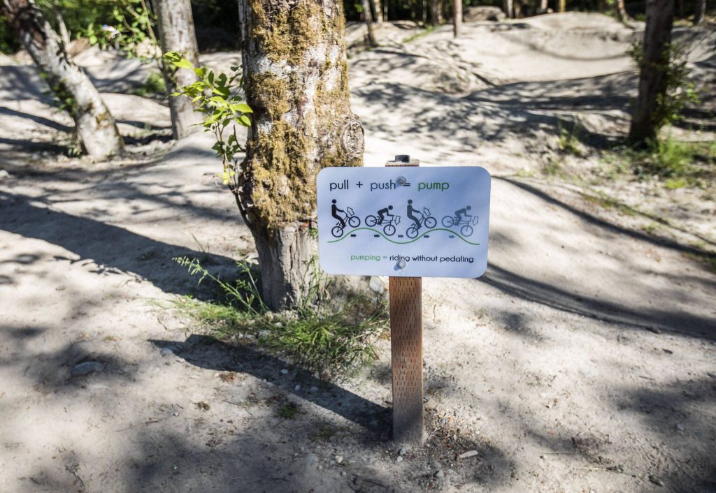 A sign with an illustration shows people how to pump on the new Mukilteo Bike Park on Wednesday, June 12, 2024 in Mukilteo, Washington. (Olivia Vanni / The Herald)